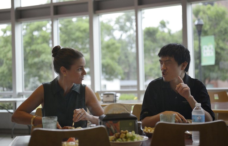 Hillary Brown, a student support specialist at the Autism Training Center, talks with Evan Badesch during lunch at Marshall University in Huntington, W.Va. (Julia Rendleman / Pittsburgh Post-Gazette) 