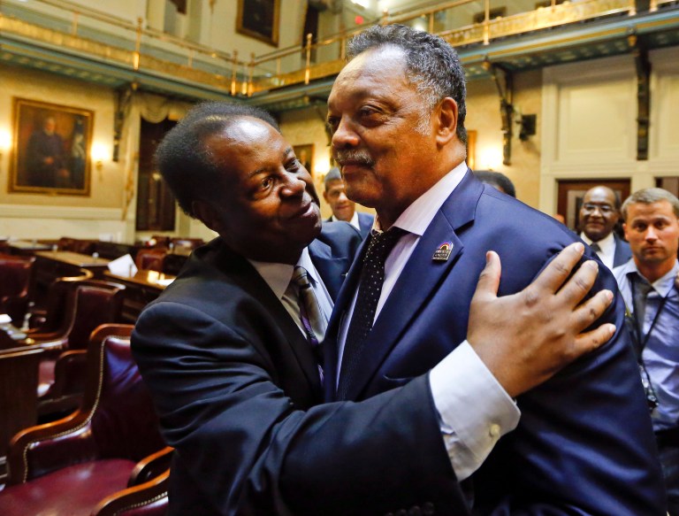 Rep. Carl Anderson, D-Georgetown, left, embraces Rev. Jesse Jackson after the House approved a bill removing the Confederate flag from the Capitol grounds early Thursday, July 9, 2015, in Columbia, S.C. (AP Photo/John Bazemore)