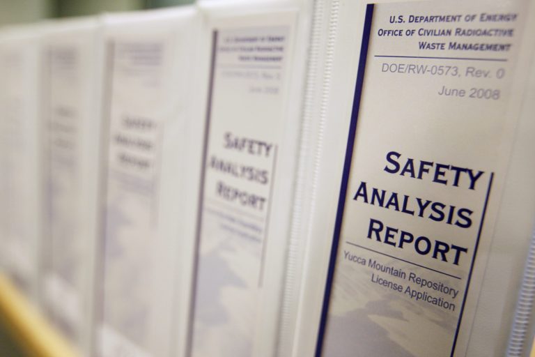Binders making up the 17 volumes which contain the Energy Department's application to build a nuclear waste dump at Yucca Mountain in Nevada are displayed shortly after they were delivered to the offices of the Nuclear Regulatory Commission on June 3, 2008. The federal government has yet to rule on whether Yucca can safely store waste in the long term. A 1982 federal law says the government must evaluate whether Yucca can perform that function. (AP Photo/Charles Dharapak)