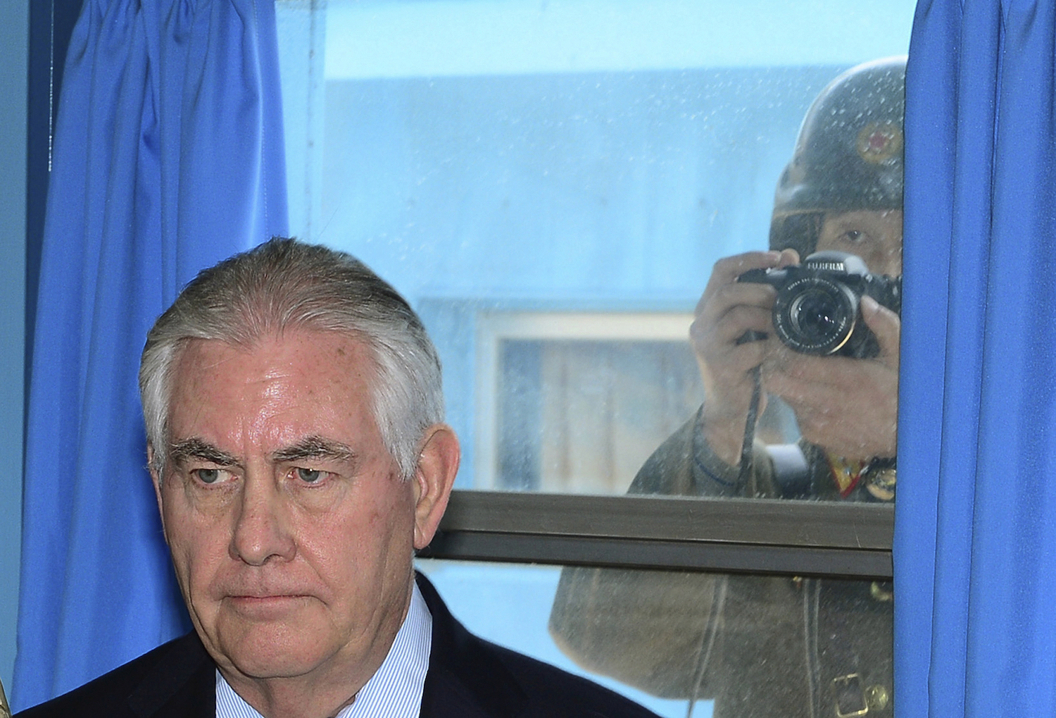 North Korean soldier sneakily snaps a picture of Rex Tillerson through a window