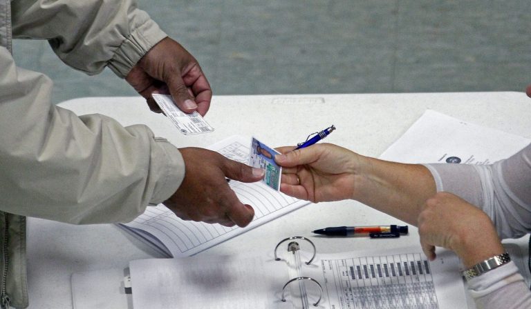 Civil rights groups are challenging a controversial overhaul of North Carolinaâs election laws that require government-issued photo IDs at the polls and shorten early voting. (AP/Rogelio V. Solis)