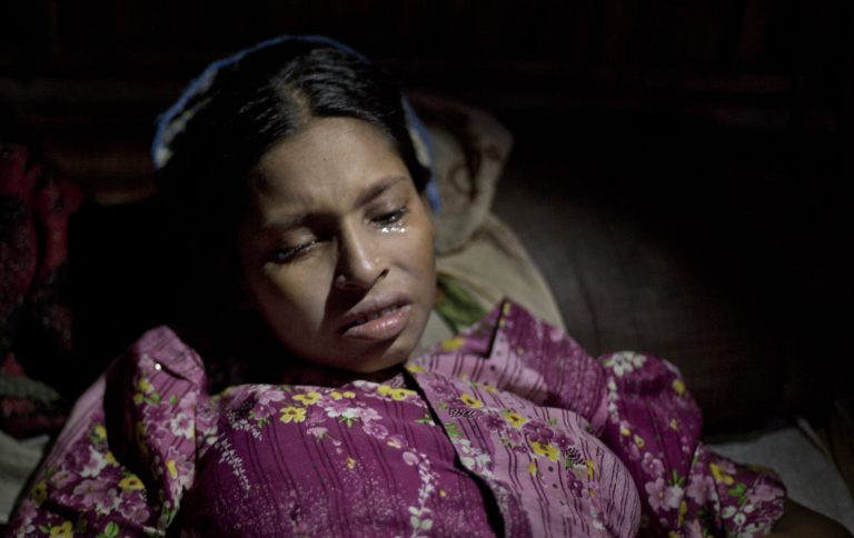 In this June 27, 2014 photo, tears roll down the face of Shamshu Nahad after she learned that her newly born daughter has died in Dar Paing, a camp for Rohingya Muslims in north of Sittwe, Rakhine state, Myanmar. Living under apartheid-like conditions, she and other residents have little or no access to life-saving medical care, food, clean water, or jobs. (AP Photo/Gemunu Amarasinghe)