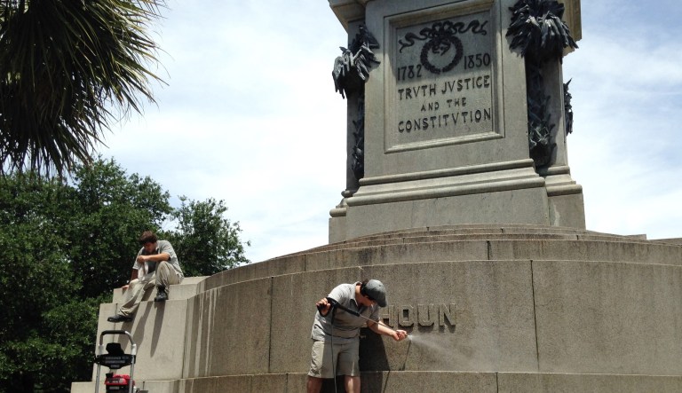 Joe Patrizzi III, a worker with Roth Restoration, is shown power-washing graffiti from a statue of John C. Calhoun, who was a vice president, U.S. senator and congressman from South Carolina, on June 23, 2015 in Charleston. The statue was defaced with the words 