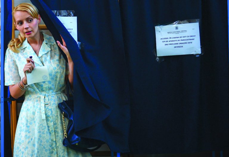 Daciana Sarbu, wife of Romanian Premier Victor Ponta, not seen, exits a voting cabin during a referendum on the Romania's president impeachment in Bucharest, Romania, Sunday, July, 29, 2012. Romania is holding a referendum on impeaching President Traian Basescu, part of a political battle that has raised questions about the rule of law in the fledgling EU member. (AP Photo/Octav Ganea)