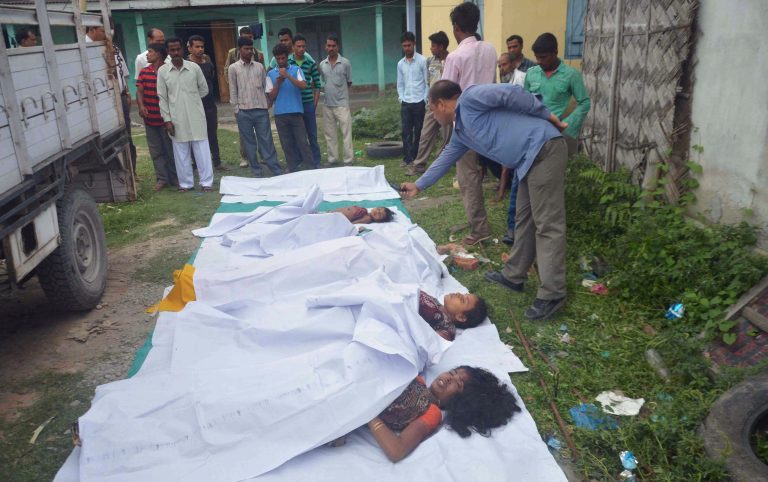 Bodies of victims are laid in a row on the ground in Kokrajhar, in the northeastern Indian state of Assam, Friday, May 2, 2014. Separatist militants opened fire with automatic weapons on Muslim villagers in remote northeastern India, killing at least 10 people, including two children, in two attacks, police said Friday. Four people were wounded. (AP Photo)