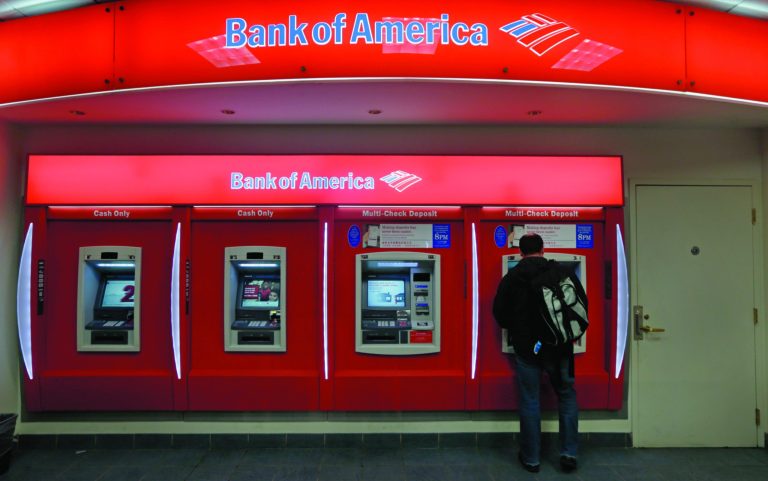 In this Dec. 13, 2012 photo, a customer stops at a Bank of America ATM office in Boston. Bank of America Corp. says it will spend more than $10 billion to settle mortgage claims resulting from the housing meltdown. Under the deal announced Monday, Jan. 7, 2013, the bank will pay $3.6 billion to Fannie Mae and buy back $6.75 billion in loans that the North Carolina-based bank and its Countrywide banking unit sold to the government agency from Jan. 1, 2000 through Dec. 31, 2008. That includes about 30,000 loans. (AP Photo/Charles Krupa)