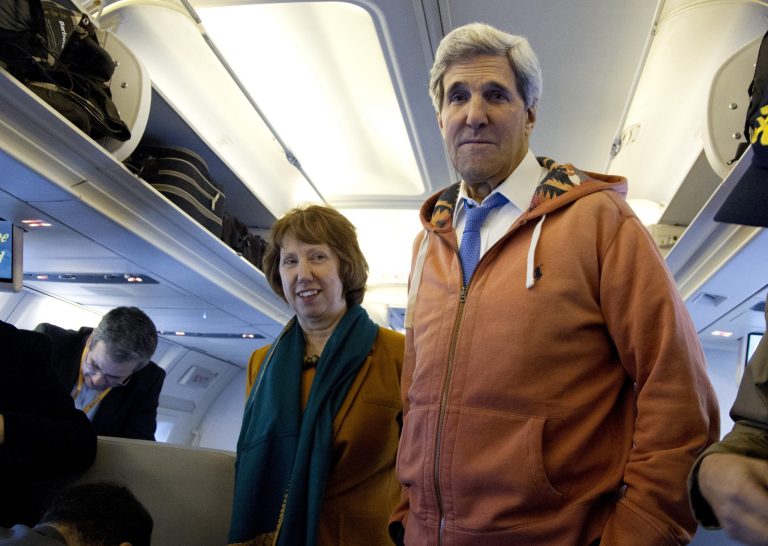 U.S. Secretary of State John Kerry, right, and EU foreign policy chief Catherine Ashton, left, visit the media seating area of Kerry's aircraft as it sits on the tarmac at Geneva International airport before leaving for London, Sunday, Nov. 24, 2013, in Geneva, Switzerland. A deal has been reached between six world powers and Iran that calls on Tehran to limit its nuclear activities in return for sanctions relief, the French and Iranian foreign ministers said early Sunday. (AP Photo/Carolyn Kaster, Pool)