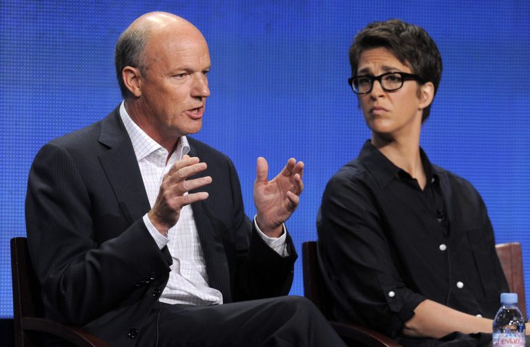 FILE - This Aug. 2, 2011 file photo shows MSNBC President Phil Griffin, left, answering a question as Rachel Maddow, host of 