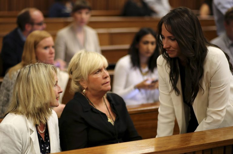 Aimee Pistorius, sister of Oscar Pistorius, right, talks to June Steenkamp, left, mother of the late Reeva Seenkamp, and friend Jenny Strydom, center, before court hearings begins  Monday March 17, 2014. Oscar Pistorius is on trial for the murder of his girlfriend Reeva on Valentines Day 2013. (AP Photo/Siphiwe Sibeko, Pool)