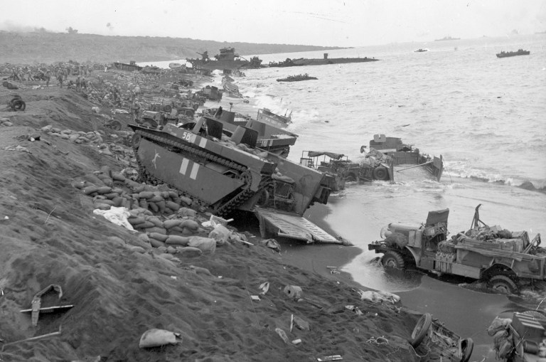 U.S. Marine Corps amtracs and trucks surge up onto the shore during the battle of Iwo Jima during World War II. (AP Photo)