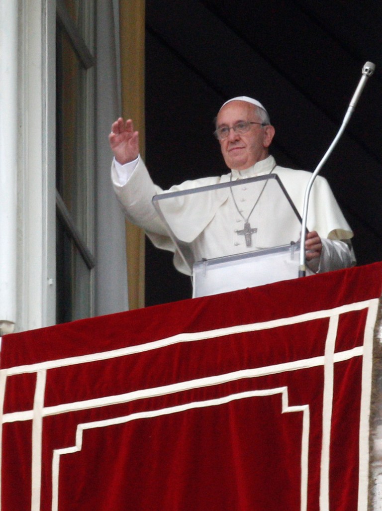 Pope Francis waves to faithful from his studio window overlooking St. Peter's square during the Angelus noon prayer at the Vatican, Sunday, June 15, 2014. (AP Photo/Riccardo De Luca)