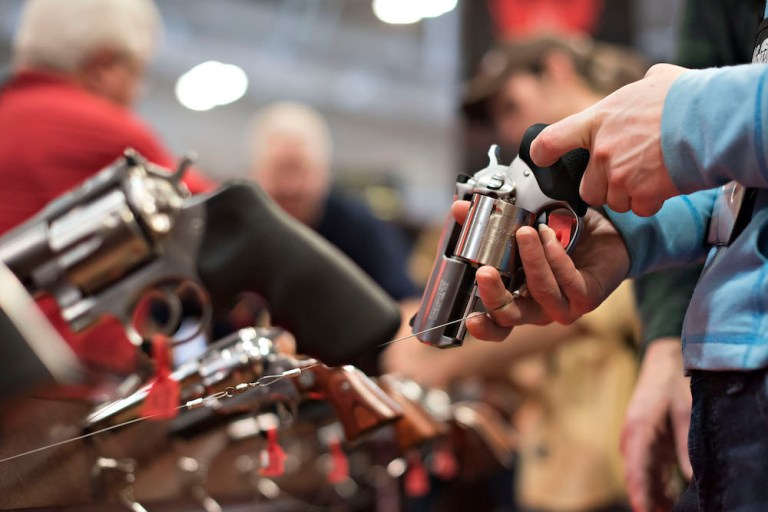 An attendee handles a revolver in the Sturm, Ruger & Co. booth at the National Rifle Association's 2015 annual meeting. The company's stock, and that of rival American Outdoor Brands, rose Thursday as President Trump defended the rifle association while considering heightened gun-safety measures. (Daniel Acker/Bloomberg)