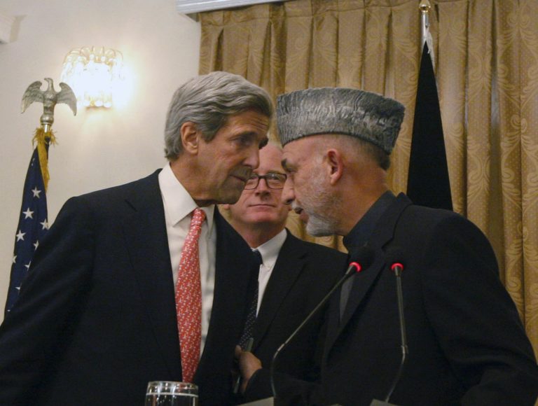   FILE - In this Oct. 20, 2009 file photo, Afghan President Hamid Karzai, right, whispers with the U.S. Sen. John Kerry, D-Mass, left, as Kai Eide head of the United Nations Assistance Mission in Afghanistan is seen, center, during a press conference, in Kabul, Afghanistan on Tuesday, Oct. 20, 2009. Kerry, President Barack Obamaâs choice for secretary of state, is a familiar face to the world leaders vital to American interests. (AP Photo/Musadeq Sadeq)  