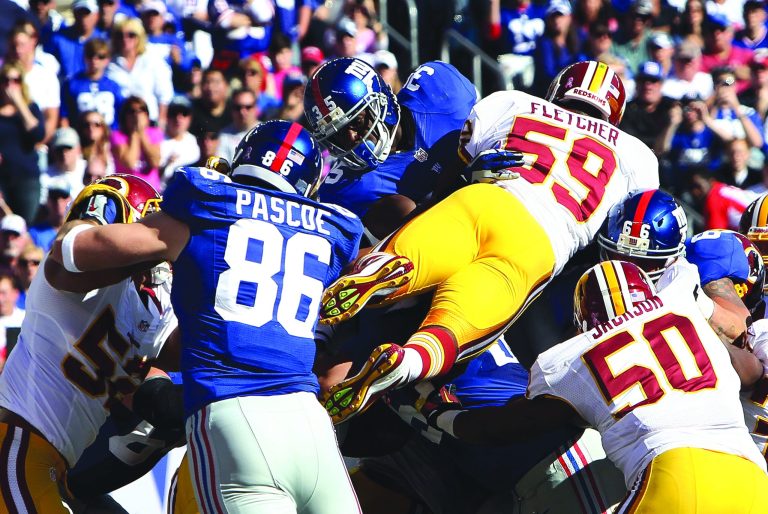 Alex Trautwig/Getty Images
London Fletcher, who later injured his hamstring, couldn't keep Andre Brown out of the end zone in the Redskins' loss to the Giants.