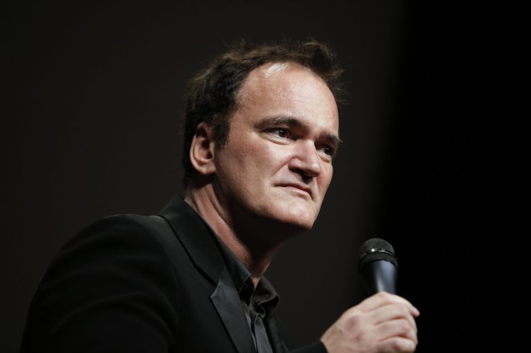 FILE - In this Oct. 18, 2013 file photo, director Quentin Tarantino  delivers a speech before receiving the Lumiere Award during the 5th edition of the Lumiere Festival, in Lyon, central France. Tarantino sued Gawker Media LLC on Monday, Jan. 27, 2014, in Los Angeles for copyright infringement over the site's posting of a story that linked to a leaked copy of his script for a planned film called 