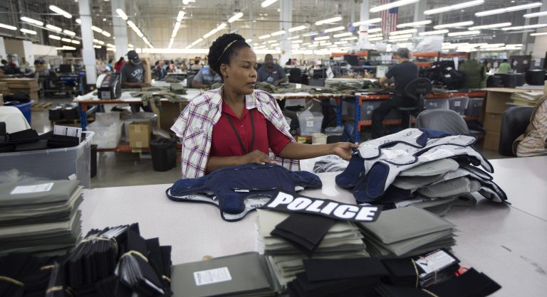 In this Sept. 19, 2014 photo, Laurette Eugene assembles a body armor vest at the Point Blank Body Armor factory in Pompano Beach, Fla. Institute for Supply Management releases its manufacturing index for September on Wednesday, Oct. 1, 2014. (AP Photo/J Pat Carter)
