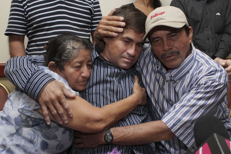 Jose Salvador Alvarenga, a fisherman who says he drifted at sea for more than a year surviving on raw fish, turtles and bird blood is embraced by his parents, Ricardo Orellana, right, and Maria Julia Alvarenga during a news conference in San Salvador, El Salvador, Tuesday, Feb. 18, 2014.  Alvarenga, 37, underwent a battery of tests after returning home from the Marshall Islands, where he showed up after what he has described as 6,500-mile (10,500-kilometer) journey from Mexico that began when his small fishing boat was thrown off course by bad weather. Alvarenga said he wouldn't be returning to his hometown of Garita Palmera, but he did not say where he was headed. (AP Photo/Salvador Melendez)