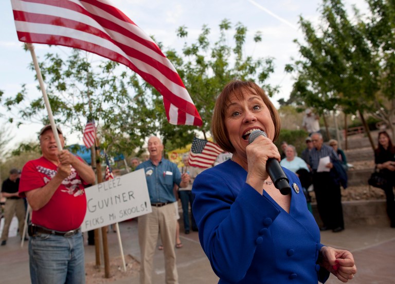 In this file photo taken, Friday, April 15, 2011, in Las Vegas, congressional candidate and former Harry Reid foe Sharron Angle, right, sings during a rally by tea party supporters. Leaders of the loosely organized, sprawling tea party effort say they hope to wield influence in 2012, when both Congress and the White House will be up for grabs.  And Nevada, one of the first states to birth a hearty community of tea party followers and the home of the third presidential nominating contest of 2012, is one place where tea party followers hope to make a difference. (AP Photo/Julie Jacobson)