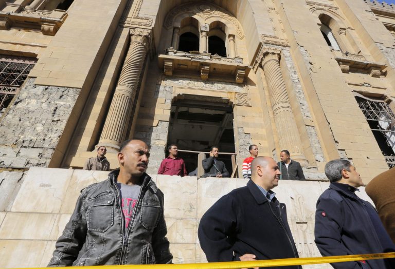 Egyptian plainclothes policemen stand guard in front of the Museum of Islamic Art at the site of a suicide car bomb at the Egyptian police headquarters in downtown Cairo, Egypt, Friday, Jan. 24, 2014. Egypt's antiquities minister, Mohammed Ibrahim, said the explosion badly damaged the facade of the 19th century museum and artifacts inside, including a rare collection of Islamic art objects dating back to 1881. (AP Photo/Amr Nabil)