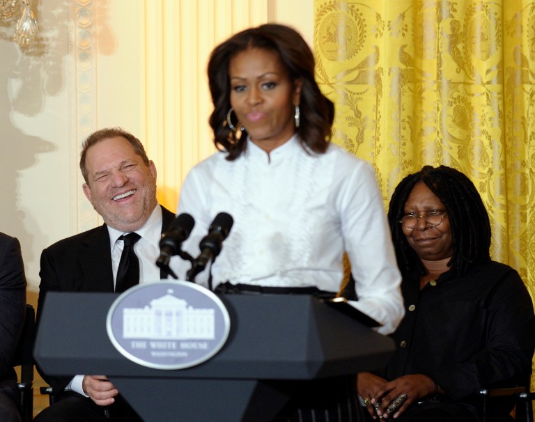 Movie mogul Harvey Weinstein, left, and Academy Award winning actress Whoopie Goldberg, listen as first lady Michelle Obama speaks in the East Room of the White House in Washington, Friday, Nov. 8, 2013, at a workshop for high school students from Washington, New York and Boston about careers in film. (AP Photo/Susan Walsh)