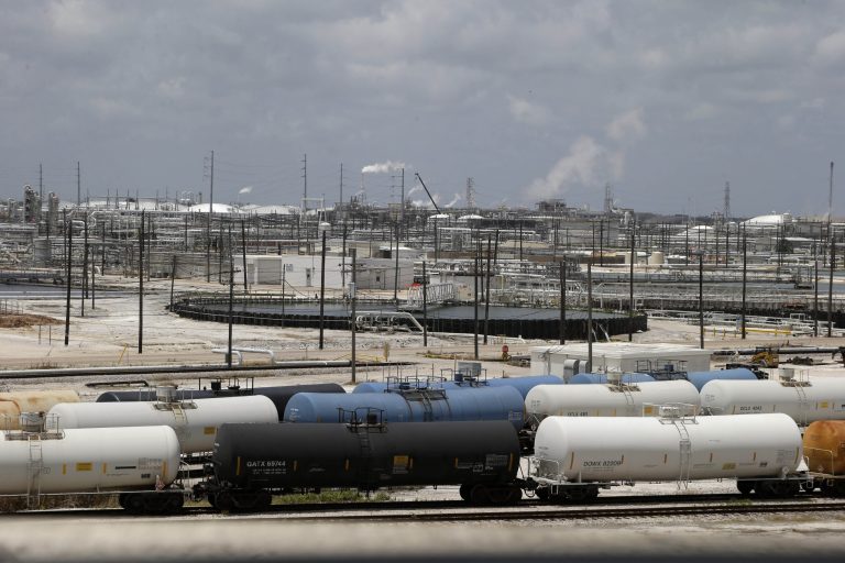 Railroad tanker cars line alongside a Dow Chemicals plant in Freeport, Texas. The plan from Dow Chemical and the Nature Conservancy calls for growing thick groves of trees to capture pollutants downwind from a chemical plant. (AP Photo/Pat Sullivan)