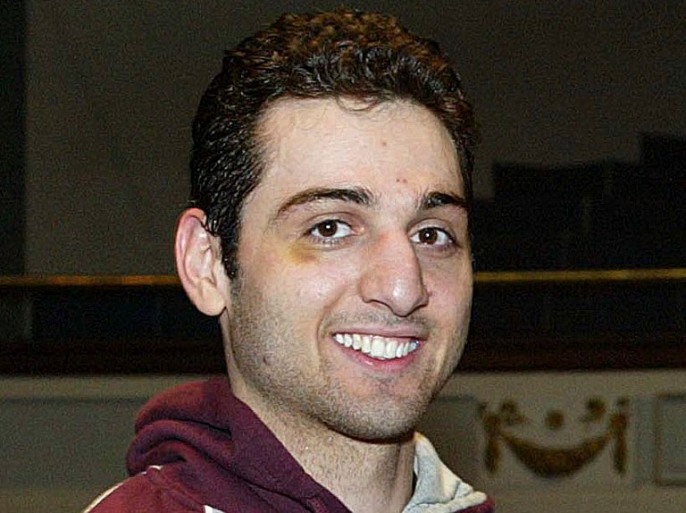 FILE - In this Feb. 17, 2010, photo, Tamerlan Tsarnaev smiles after accepting the trophy for winning the 2010 New England Golden Gloves Championship in Lowell, Mass. Tsarnaev is the Boston Marathon bombing suspect who was killed in a police shootout. His uncle, Ruslan Tsarni, told The Associated Press Friday, May 10, 2013, that the body was buried in Virginia with the help of a 