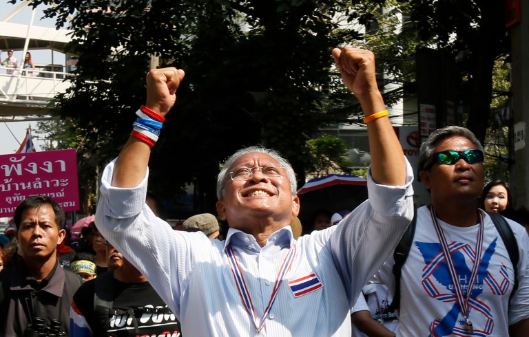 Anti-government protest leader Suthep Thaugsuban waves to supporters during a march through Bangkok, Thailand, Monday, Feb. 3, 2014. Thai protesters vowed Monday to stage larger rallies in central Bangkok and push ahead their efforts to nullify the results of elections that were expected to prolong a national political crisis. (AP Photo/Wally Santana)