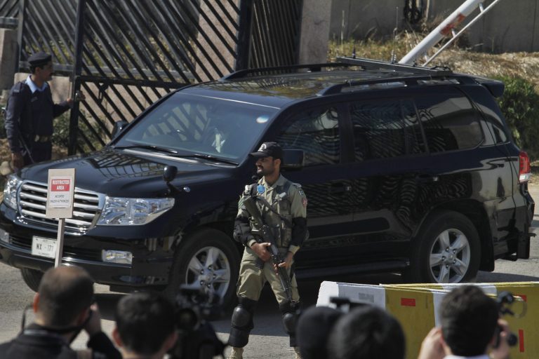 A paramilitary soldier stands guard as the vehicle of former Pakistani President Pervez Musharraf leaves after his court appearance in Islamabad, Pakistan, Tuesday, Feb. 18, 2014. Musharraf has appeared for the first time in front of a court tasked with hearing a high treason case against him. The Tuesday appearance was Musharraf's first in front of the court since proceedings started on Dec. 24, 2013. (AP Photo/Anjum Naveed)
