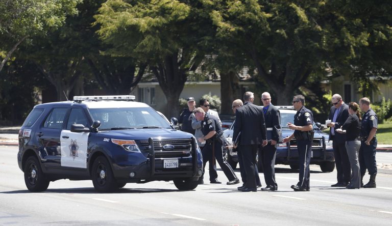 San Jose police investigate the scene of an officer involved shooting in the 700 block of Blossom Hill Rd. Thursday, Aug. 14, 2014, in San Jose, Calif. There were reports that a San Jose police officer or officers shot a woman who was reported to be threatening to shoot members of her family in south San Jose near the Oakridge Mall. (AP Photo/Bay Area News Group, Patrick Tehan)
