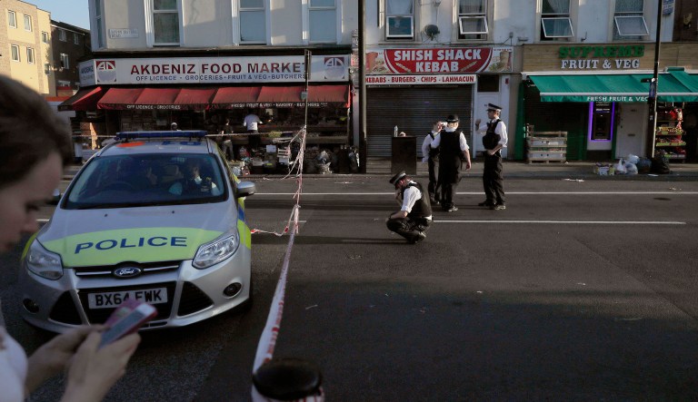 Police officers work at a cordoned area near Finsbury Park station after a vehicle struck pedestrians in north London early Monday morning. (AP Photo/Tim Ireland)