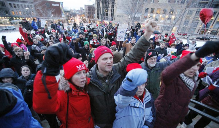 Kevin Gundlach, center, president of the South Central Federation of Labor, during The Fire Still Burns rally outside the Capitol in Madison, Wis., on Feb. 14, 2013. (AP Photo/The Capital Times, Michelle Stocker)