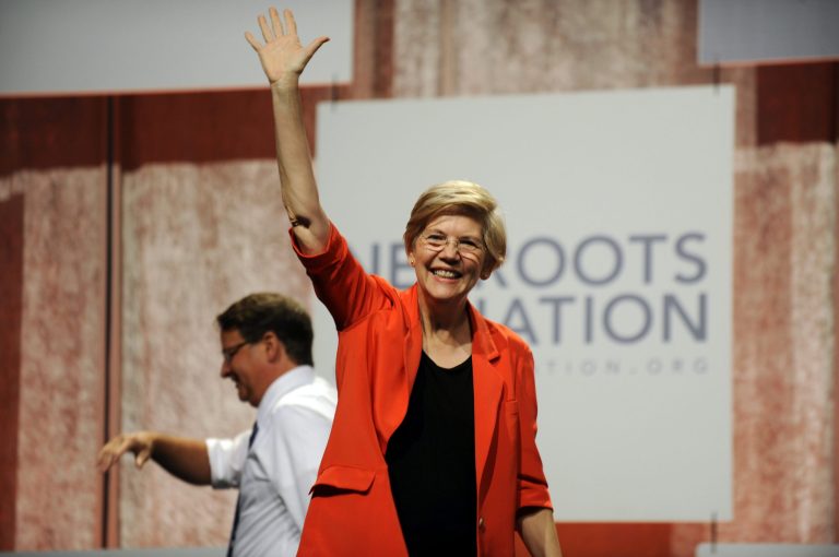 U.S. Sen. Elizabeth Warren, D-Mass., waves to the crowd after her introduction at the Netroots Nation conference in Detroit Friday. (AP Photo/Detroit News, David Coates)