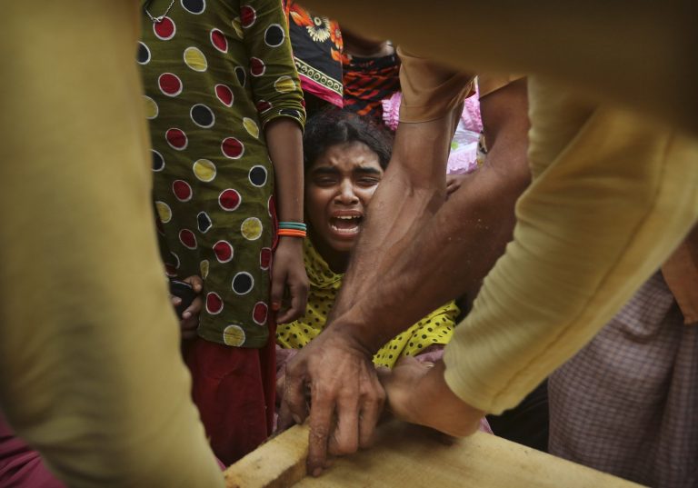 A Bangladeshi relative of garment worker Mohammed Abdullah cries as his coffin is nailed shut after collecting his body at a makeshift morgue in a schoolyard near a building that collapsed Wednesday in Savar, near Dhaka, Bangladesh, Saturday, April 27, 2013. Police in Bangladesh arrested two owners of a garment factory in a shoddily-constructed building that collapsed this week, killing hundreds of people, as protests spread to a second city Saturday with hundreds of people throwing stones and setting fire to vehicles. (AP Photo/Kevin Frayer)