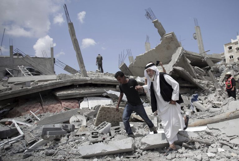 An elderly Palestinian man makes his way on the rubble of a destroyed house following Israeli strikes in Rafah refugee camp in southern Gaza Strip on Monday. (AP Photo/Khalil Hamra)