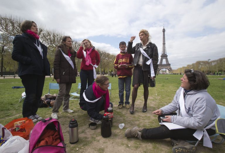Frigide Barjot, leader of the movement against gay marriage, 2nd right, talks to the media as she visits mothers, who take part in a vigil to protest against French President Francois Hollande's social reform on gay marriage and adoption next to the Eiffel tower in Paris, Monday, April 22, 2013. Both houses of the French parliament have already approved the bill in a first reading. The second and final reading is expected Tuesday. Eiffel tower is seen in the background. (AP Photo/Michel Euler)