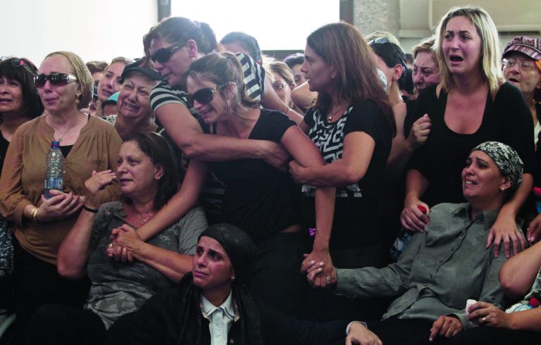FILE - In this Friday, July 20, 2012 file photo, family and friends attend the funeral of Itzik Kolengi, 28, who was killed and his wife injured in a suicide bombing in Bulgaria Wednesday in Petah Tikva, Israel. Israel's prime minister said Sunday, July 22, 2012 that his country is on alert for plots to kill more of its citizens overseas, after speculation that last week's deadly bombing of a tour bus in Bulgaria was a rehearsal for a spectacular attack on Israel's Olympics team. (AP Photo/Dan Balilty, File)