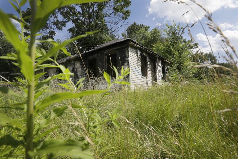An abandoned house with an overgrown lot is seen in Brightmoor, on Detroitâs northwest side. Brightmoor is one of the cityâs more blighted neighborhoods. (AP Photo/Carlos Osorio)
