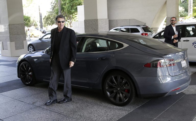 Texas Gov. Rick Perry walks over to talk to reporters after driving up in a Tesla Motors Type S electric car in Sacramento, Calif., Tuesday, June 10, 2014. Perry, the former and potential 2016 Republican presidential candidate, arrived at the meeting with statewide GOP lawmakers and officials across the street from the state Capitol. He is trying to persuade Tesla Motors, based in Palo Alto, to build a $5 billion battery plant in Texas. (AP Photo/Rich Pedroncelli)