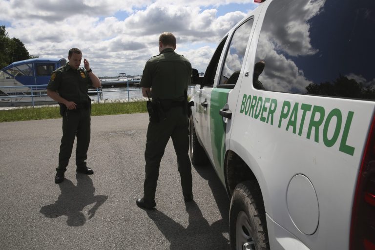 U.S. Border Patrol agents talk while at a marina on the Niagara River at the U.S.-Canada border on June 3, 2013 in Beaver Island State Park, N.Y. (Photo by John Moore/Getty Images)