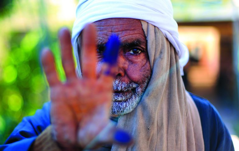 FILE - In this Saturday, Dec. 22, 2012 file photo, an elderly Egyptian man shows his inked finger after casting his vote on the second round of a referendum on a disputed constitution drafted by Islamist supporters of President Mohammed Morsi in Fayoum, about 100 kilometers (62 miles) south of Cairo , Egypt. When election-time rolls around, this impoverished rural province has proven one of Egypt's most die-hard bastions of support for Islamists, handing them lopsided victories. The referendum that approved Egypt's Islamist-backed constitution was no exception, with nearly 90 percent of voters here supporting the charter. But even here, voices of discontent with the Muslim Brotherhood are emerging, something the liberal and secular opposition is hoping to build on in upcoming parliament elections.(AP Photo/Khalil Hamra, File)