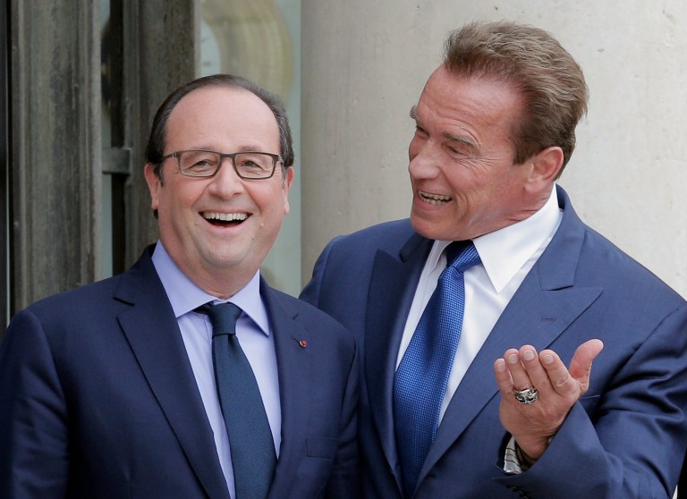Former Governor of California and founding chair of the R20 initiative, Arnold Schwarzenegger, right, jokes with French President Francois Hollande prior to a meeting at the Elysee Palace in Paris, Friday, Oct. 10, 2014. The R20 is a coalition of partners led by regional governments that work to promote and implement projects that are designed to produce local economic and environmental benefits in the form of reduced energy consumption and greenhouse gas emissions, strong local economies, improved public health, and new green jobs. (AP Photo/Christophe Ena)