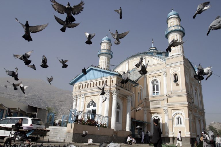 Pigeons fly as Afghans prepare to offer Eid al-Fitr prayers in Kabul, Afghanistan, Monday, July 28, 2014. Eid al-Fitr prayer marks the end of the holy fasting month of Ramadan. (AP Photo/Ahmad Nazar)