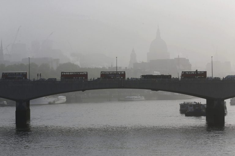 Backdropped by St. Paul's Cathedral covered in mist, people and buses cross Waterloo Bridge during the second day of a 48 hour workers strike partially closing the London Underground train network in London, Wednesday, April 30, 2014. Members of the Rail, Maritime and Transport Union went on strike over management plans to close all ticket offices on the subway network, known as the Tube, which will result in around 750 job losses from the Underground's staff of 18,000. A further 72 hour strike is planned starting May 5. (AP Photo/Sang Tan)
