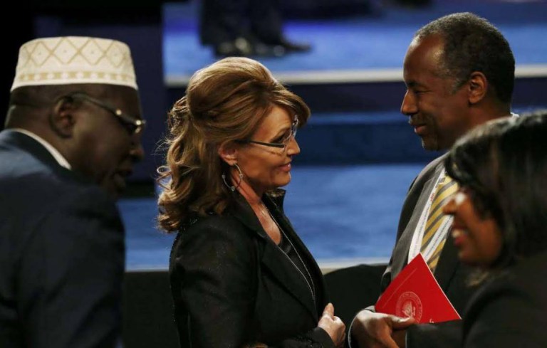 Former Republican vice presidential nominee Sarah Palin wrote in a Facebook post Friday that she was happy to meet President Obama's half-brother at Wednesday's presidential debate. But the former Alaska governor posted a photo of her talking with Dr. Ben Carson, while Malik Obama stood behind Palin. (Photo courtesy of Sarah Palin, via Facebook)