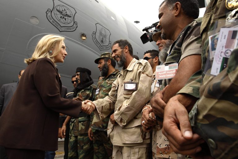 U.S. Secretary of State Hillary Rodham Clinton meets Libyan soldiers at the steps of her C-17 military transport upon her arrival in Tripoli in Libya, Tuesday Oct. 18, 2011. (AP Photo/Kevin Lamarque, Pool)