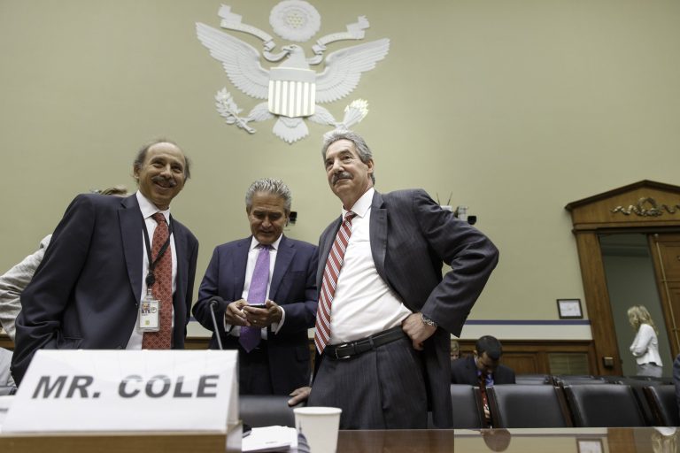 Deputy Attorney General James Cole, right, arrives on Capitol Hill in Washington, Thursday, July 17, 2014, to testify before the House  Economic Growth, Job Creation, and Regulatory Affairs subcommittee hearing on how the Justice Department is investigating allegations that the Internal Revenue Service (IRS) targeted conservative political groups for extra scrutiny.   (AP Photo/J. Scott Applewhite)