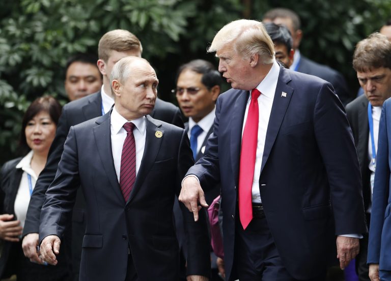 U.S. President Donald Trump, center right, and Russia's President Vladimir Putin, center left, talk during the family photo session at the APEC Summit in Danang, Saturday, Nov. 11, 2017. Trump said Putin denied interfering with the election. (Jorge Silva/Pool Photo via AP)