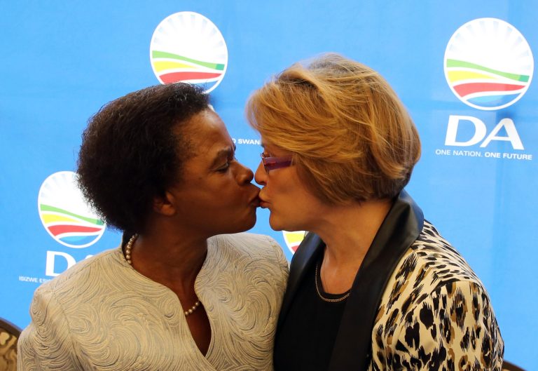 South African anti-apartheid activist Mamphela Ramphele, left, greets Helen Zille, right, the head of the South African Democratic Alliance political party during a press conference in Cape Town, South Africa, Tuesday, Jan. 28, 2014. The former anti-apartheid activist who was close to Steve Biko and was a World Bank executive merged her party Tuesday with South Africa's main opposition party, the Democratic Alliance, and will be its presidential candidate, challenging the ruling African National Congress whose popularity has eroded amid corruption scandals and other problems. (AP Photo/ Nardus Engelbrecht)