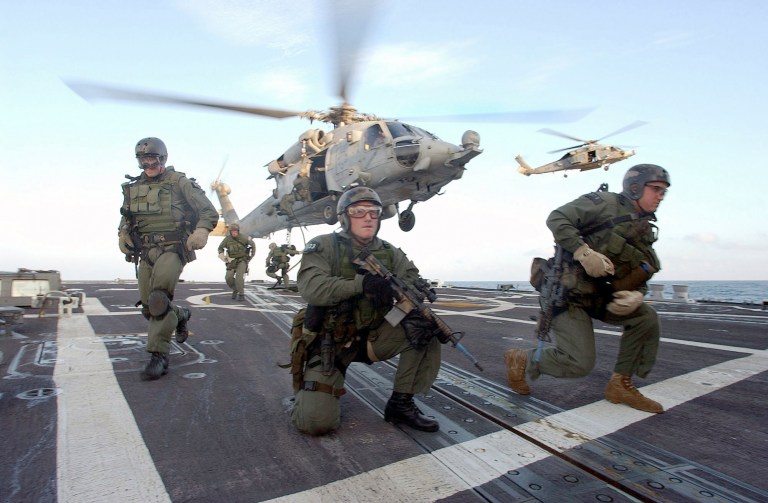 This Oct. 29, 2002, U.S.Navy photo, shows U.S. Navy SEALs at sea aboard the USS Oscar Austin after landing on the fantail of the guided missile destroyer during a training exercise. (AP Photo/U.S. Navy)