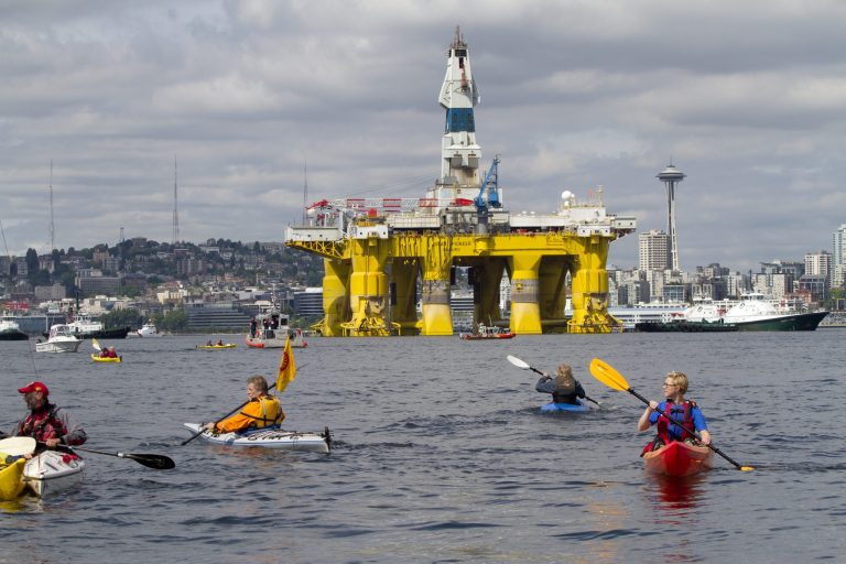 Environmental activists in kayaks protest the arrival of the Polar Pioneer, an oil drilling rig owned by Shell Oil, on May 14, 2015 in Seattle, Washington. The rig is part of a fleet that will lead a controversial oil-exploration effort off Alaska's North Slope. (Photo by Karen Ducey/Getty Images)